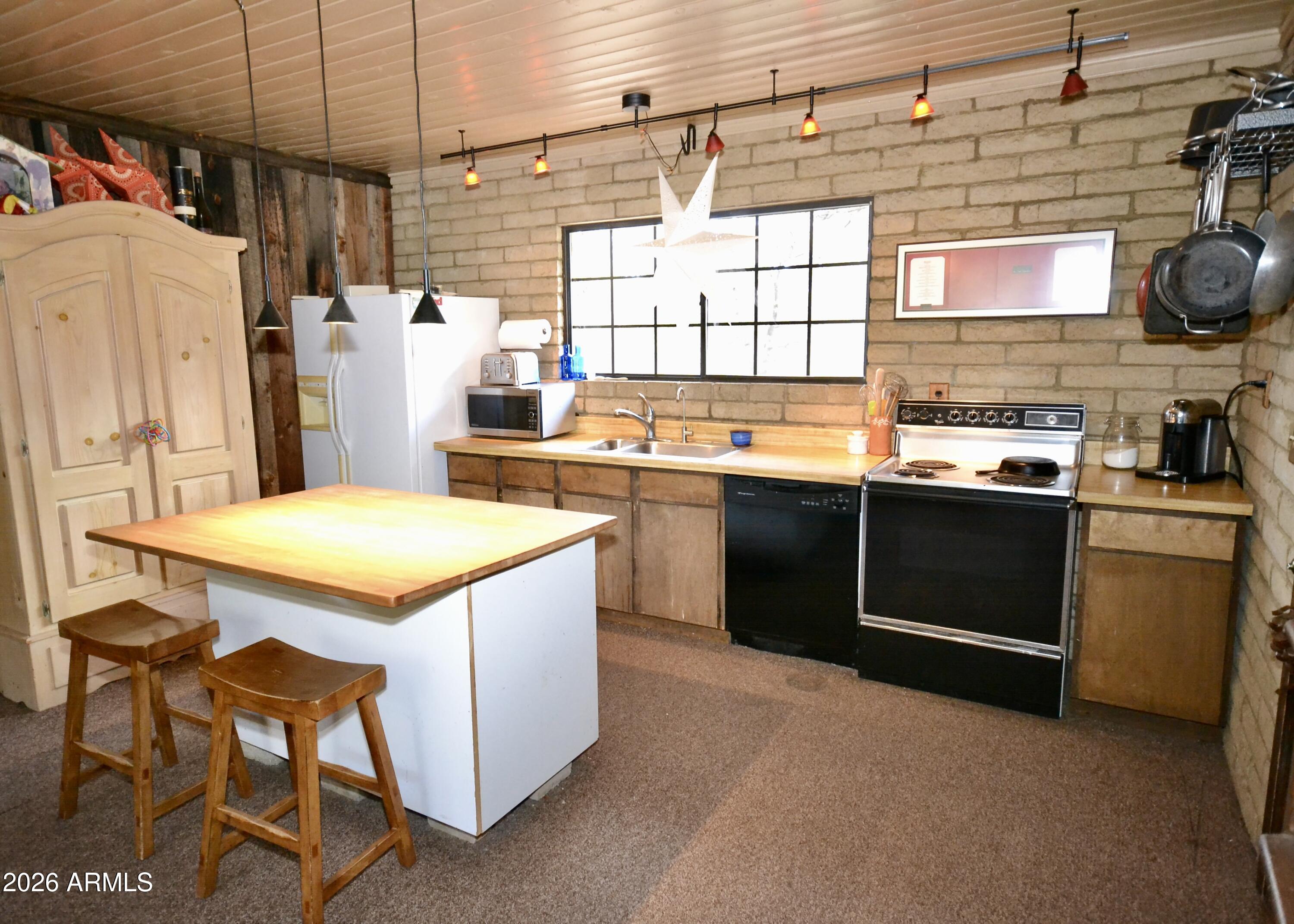 23617 South Demascus Road Crown King, AZ 86343 - Photo 6 of 50 a kitchen with a sink a stove a refrigerator and cabinets
