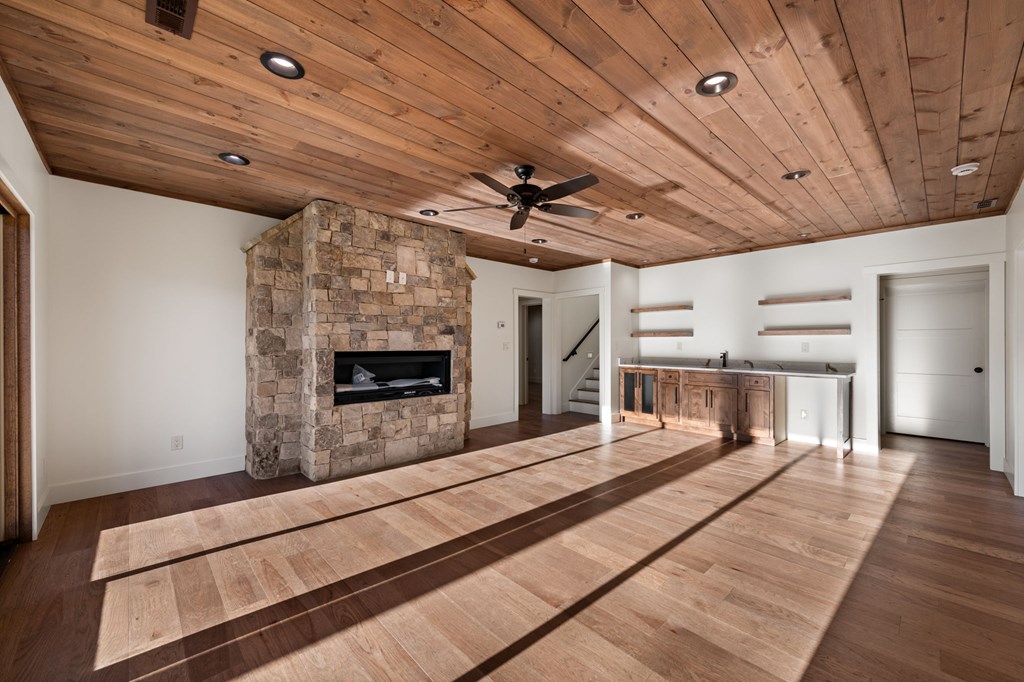770 Fish Hook Point Blue Ridge, GA 30513 - Photo 52 of 96 2nd Lower Level Living Area, 2nd Lower Level features Full Wet Bar + Stained Ceilings + Gas Fireplace + Storage Behind Bar + Guest Bedroom 2, 3 & 4 + Full Bathroom w/ Walk In Shower | Slider Doors lead to deck & Lake Access