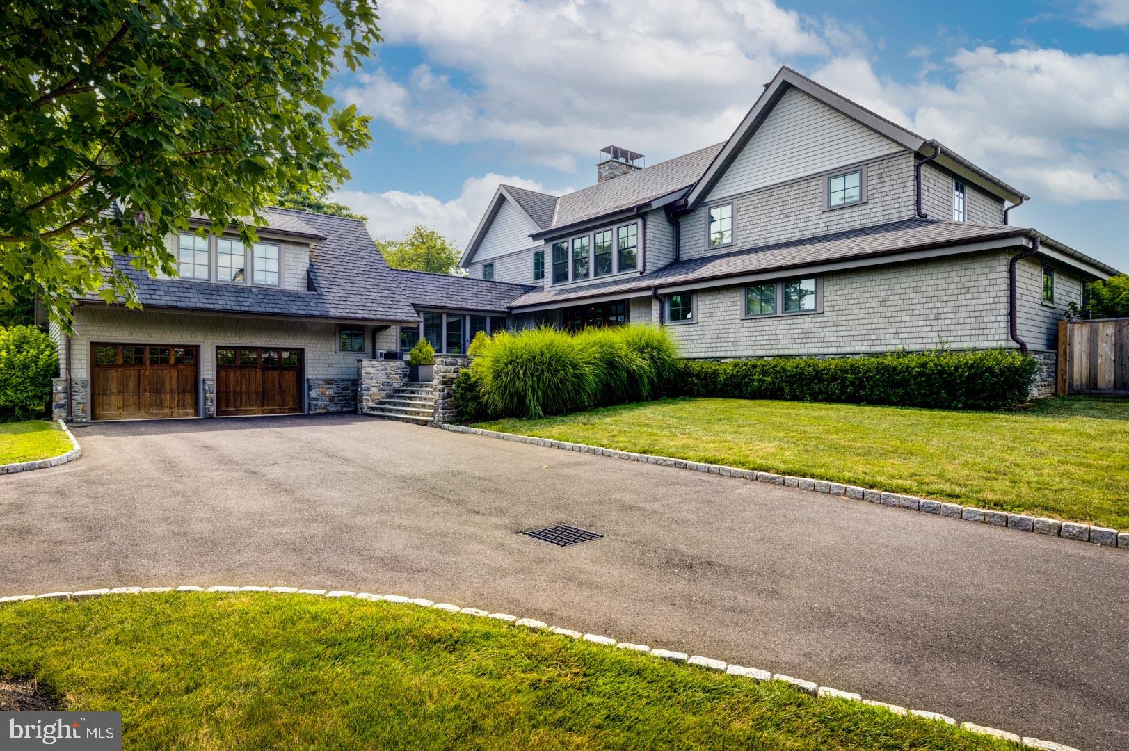 a view of a house with a yard and large tree