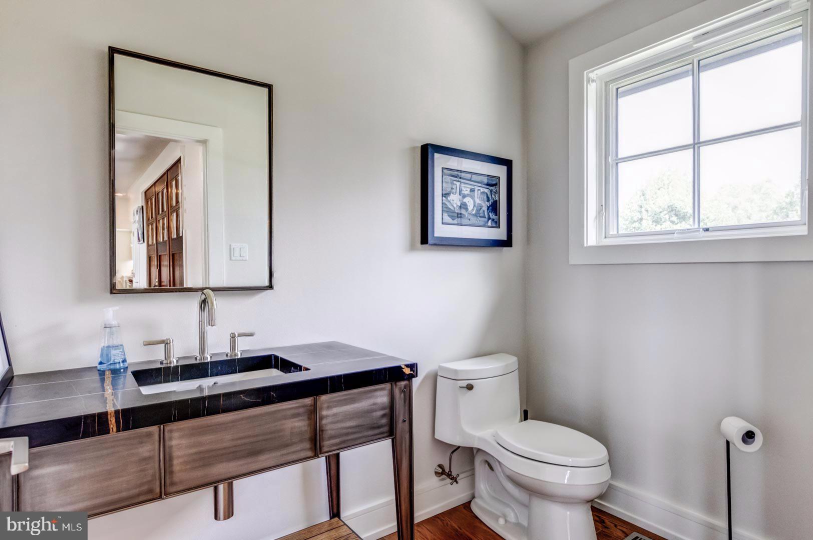 609 St Andrews Road Philadelphia, PA 19118 - Photo 15 of 31 a bathroom with a toilet a sink and a mirror