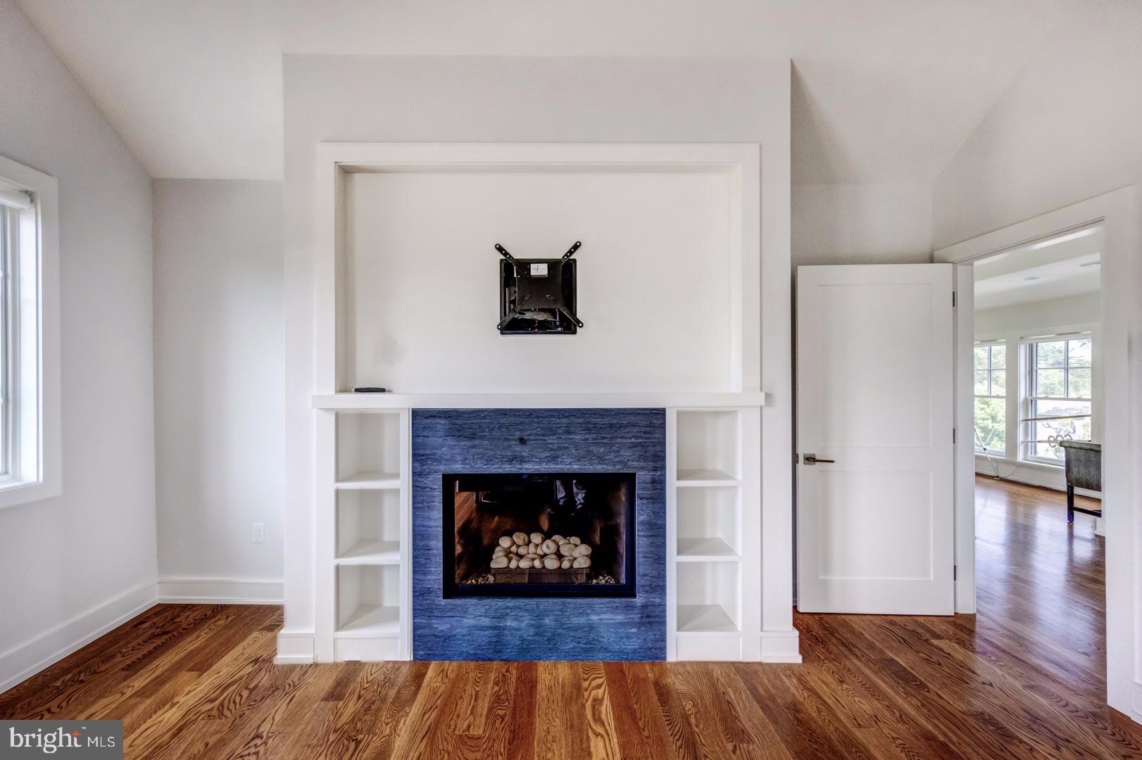 609 St Andrews Road Philadelphia, PA 19118 - Photo 24 of 31 a living room with wooden floor and a fireplace