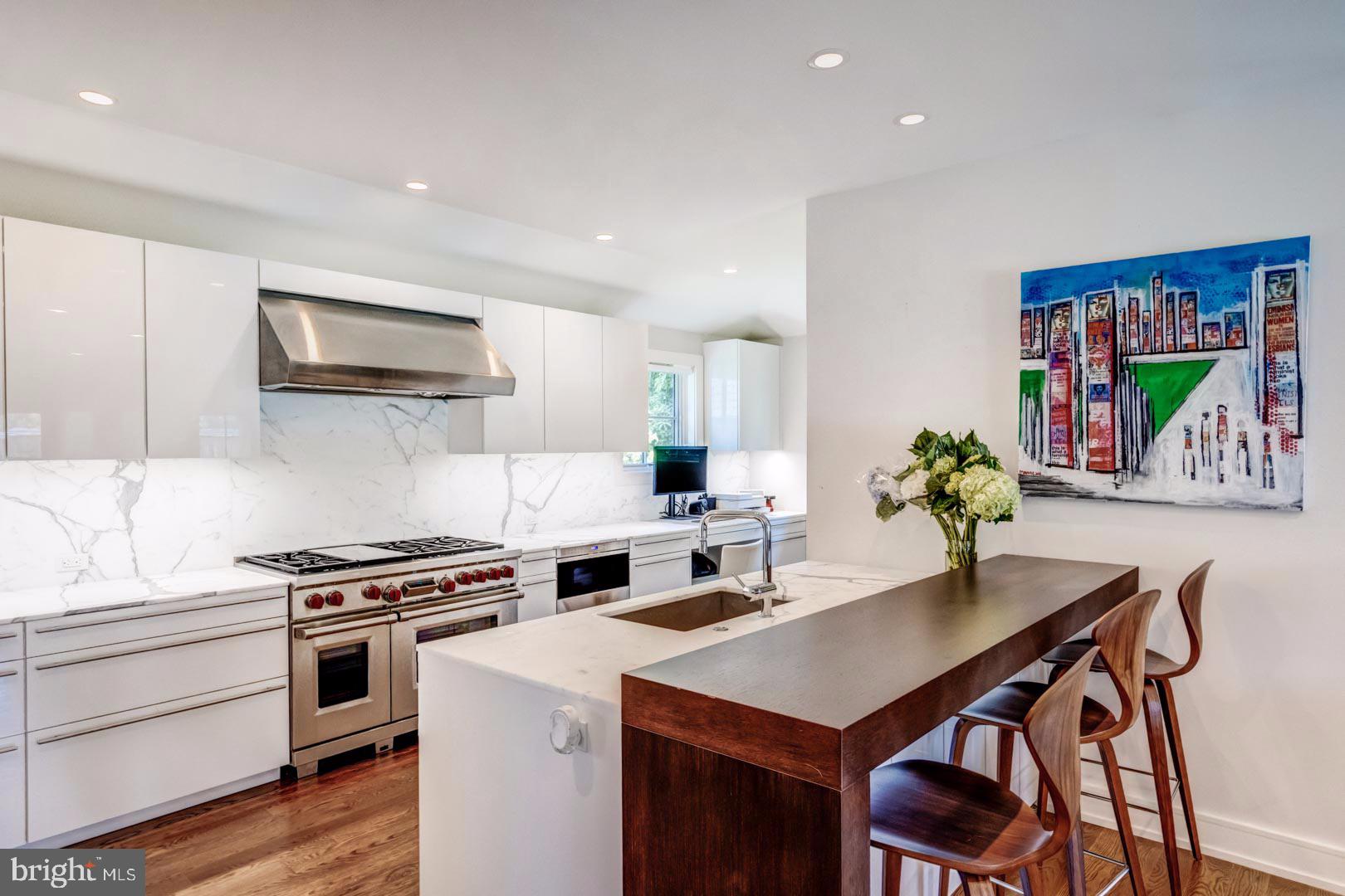 609 St Andrews Road Philadelphia, PA 19118 - Photo 8 of 31 a kitchen with a stove a microwave a dining table and chairs