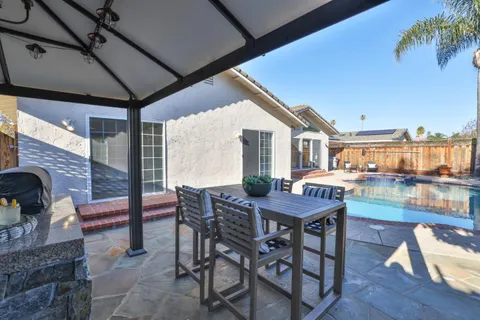 a view of a patio with a table chairs and a table