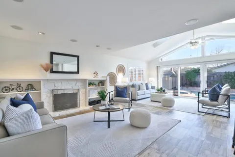 a living room with furniture and a fireplace