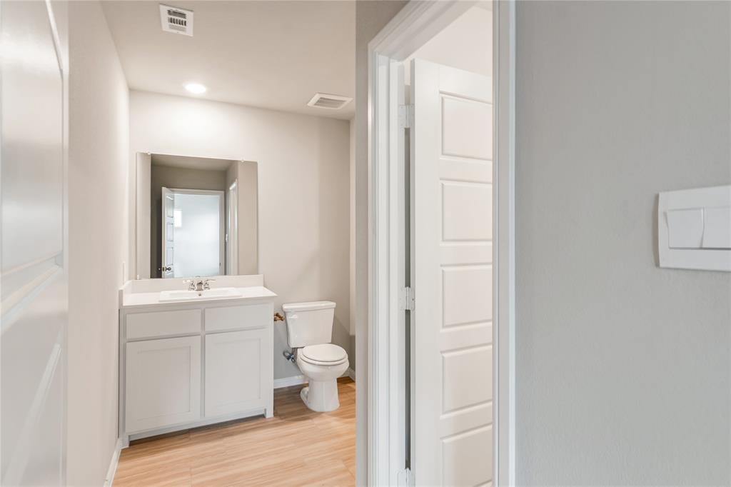 3137 Pecan Farm Lane Fort Worth, TX 76140 - Photo 13 of 31 a bathroom with a toilet a sink and mirror