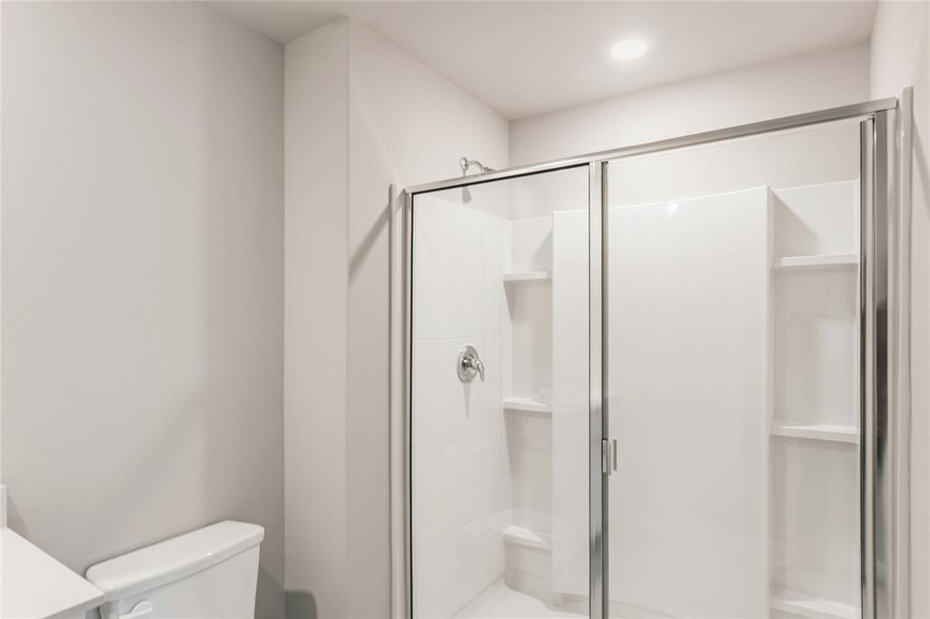 3137 Pecan Farm Lane Fort Worth, TX 76140 - Photo 14 of 31 a bathroom with a glass shower door
