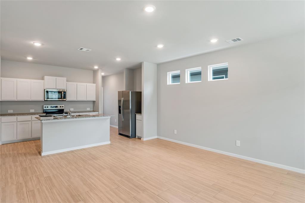 3137 Pecan Farm Lane Fort Worth, TX 76140 - Photo 31 of 31 a kitchen with stainless steel appliances refrigerator sink and stove