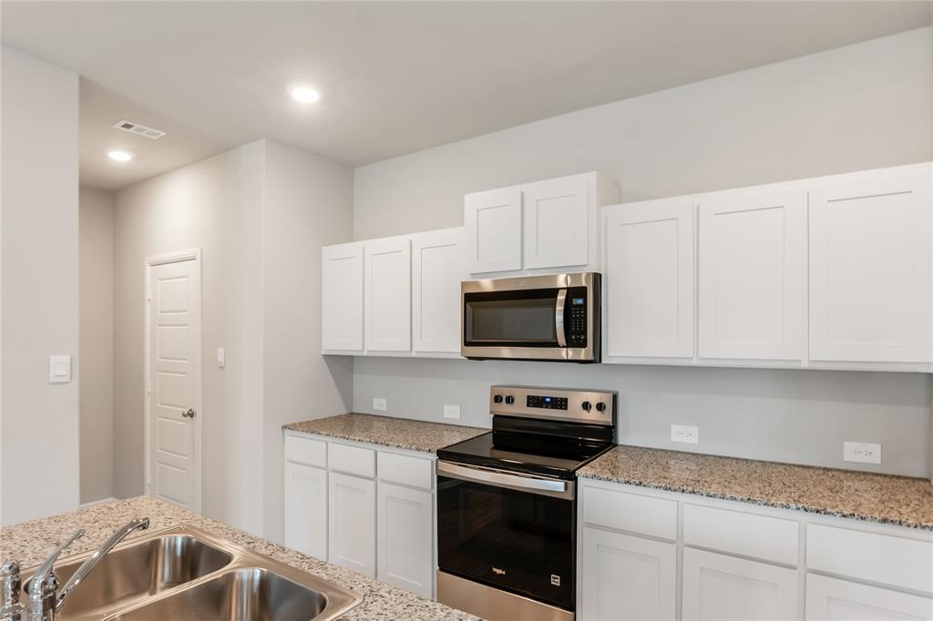 3137 Pecan Farm Lane Fort Worth, TX 76140 - Photo 21 of 31 a kitchen with a sink and steel appliances