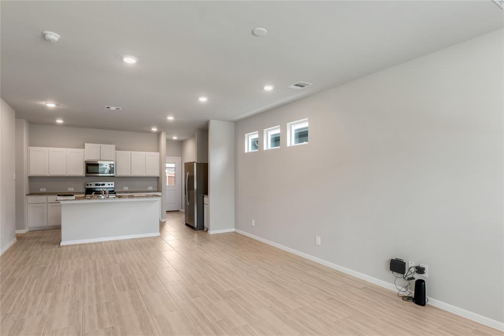 3137 Pecan Farm Lane Fort Worth, TX 76140 - Photo 30 of 31 a kitchen with a refrigerator and a stove top oven