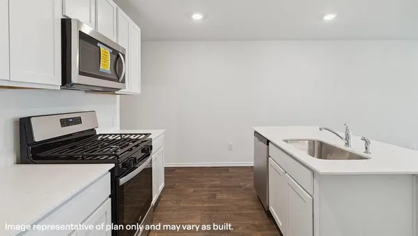 a kitchen that has a sink and a stove
