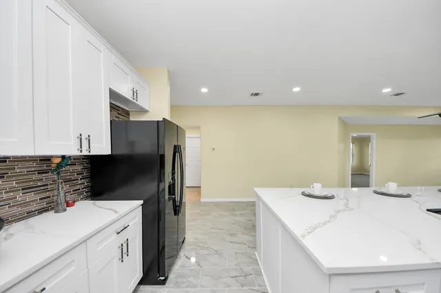 a kitchen with a sink and refrigerator