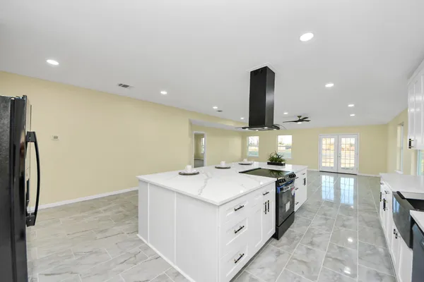 a kitchen with a stove a sink and a refrigerator