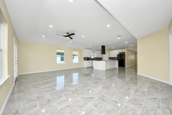 a view of kitchen with furniture and refrigerator