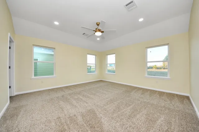 wooden floor in an empty room with a bathroom