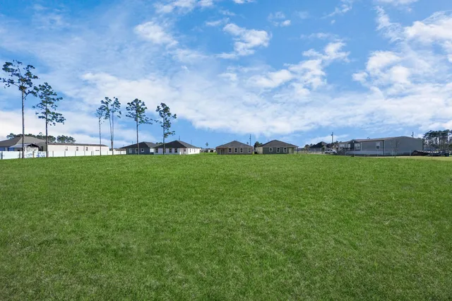a view of a big yard with a garden