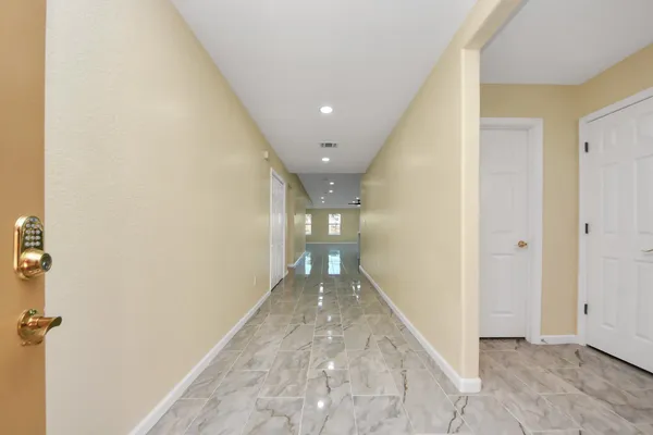 a view of hallway with a bathroom