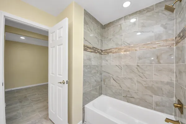 a bathroom with a bathtub and a shower