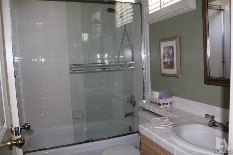 11212 Terraceridge Road Moorpark, CA 93021 - Photo 18 of 26 a bathroom with a granite countertop sink a toilet and shower