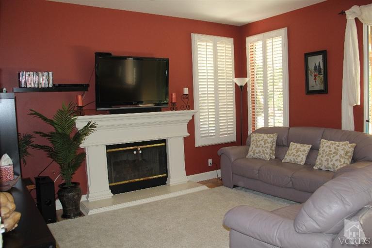 11212 Terraceridge Road Moorpark, CA 93021 - Photo 10 of 26 a living room with furniture a flat screen tv and a fireplace