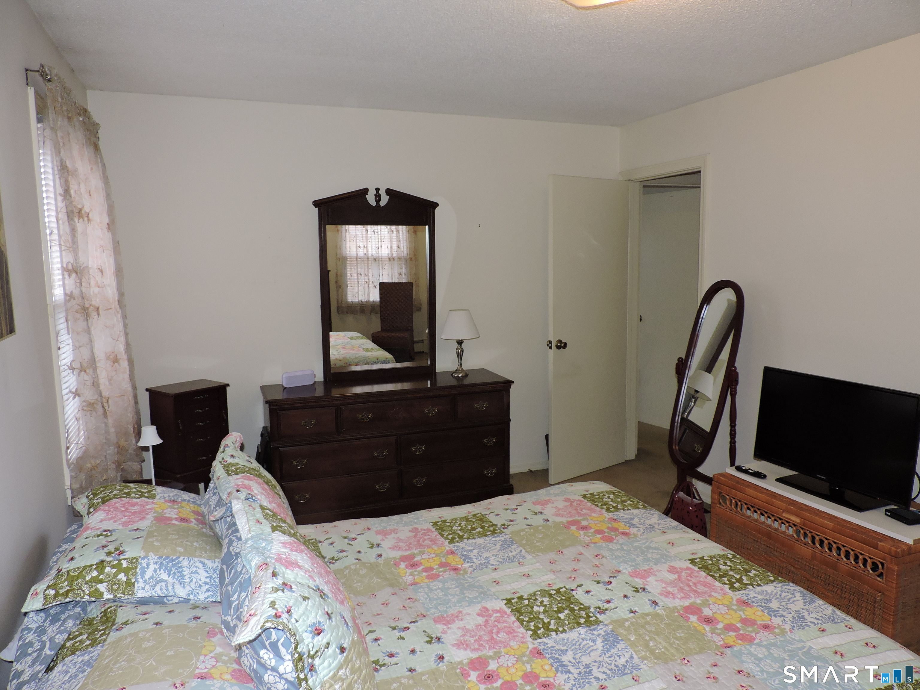 814 Graham Road South Windsor, CT 06074 - Photo 13 of 23 a bedroom with a bed and a flat screen tv