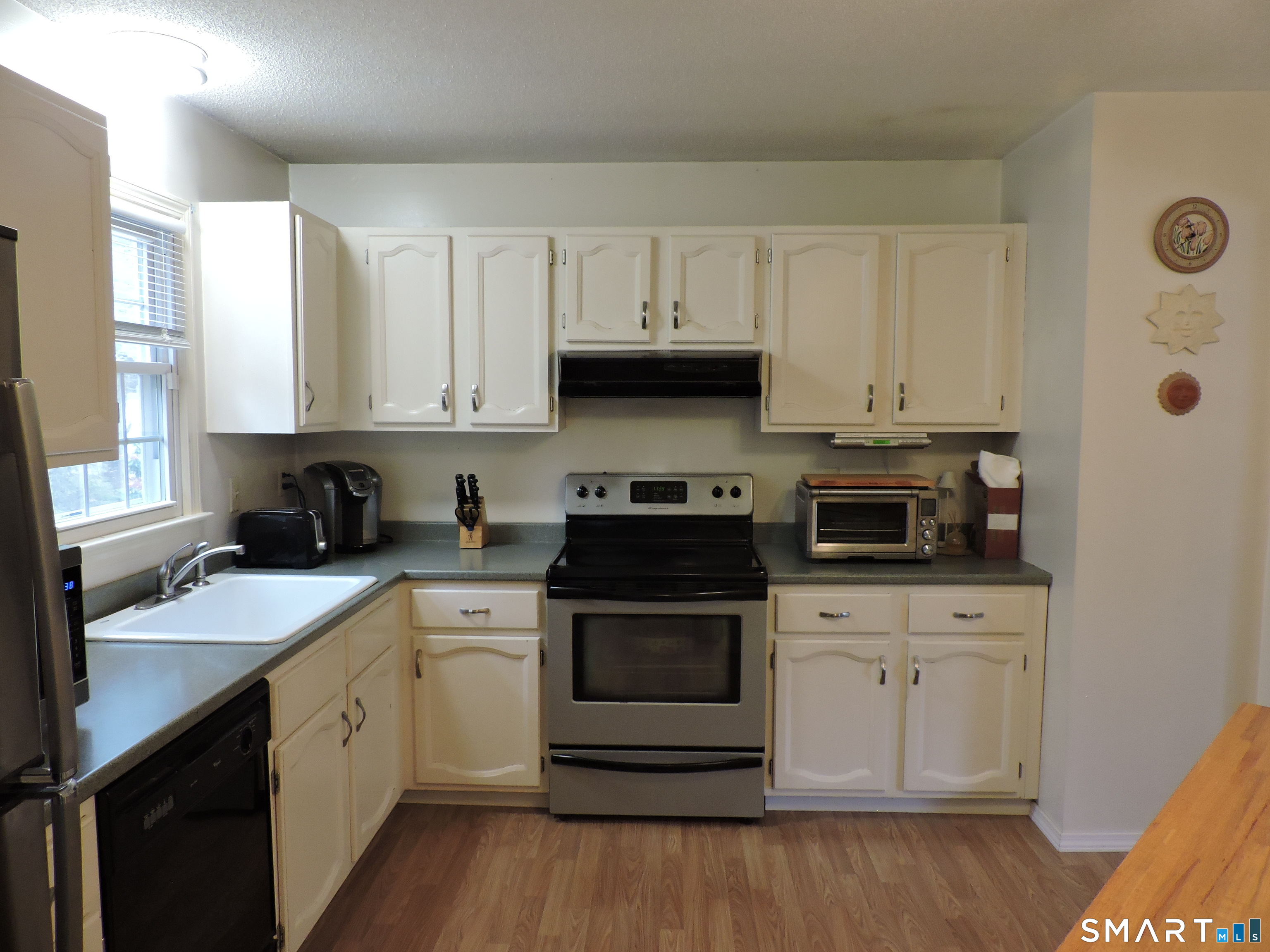 814 Graham Road South Windsor, CT 06074 - Photo 8 of 23 a kitchen with a sink stove and cabinets