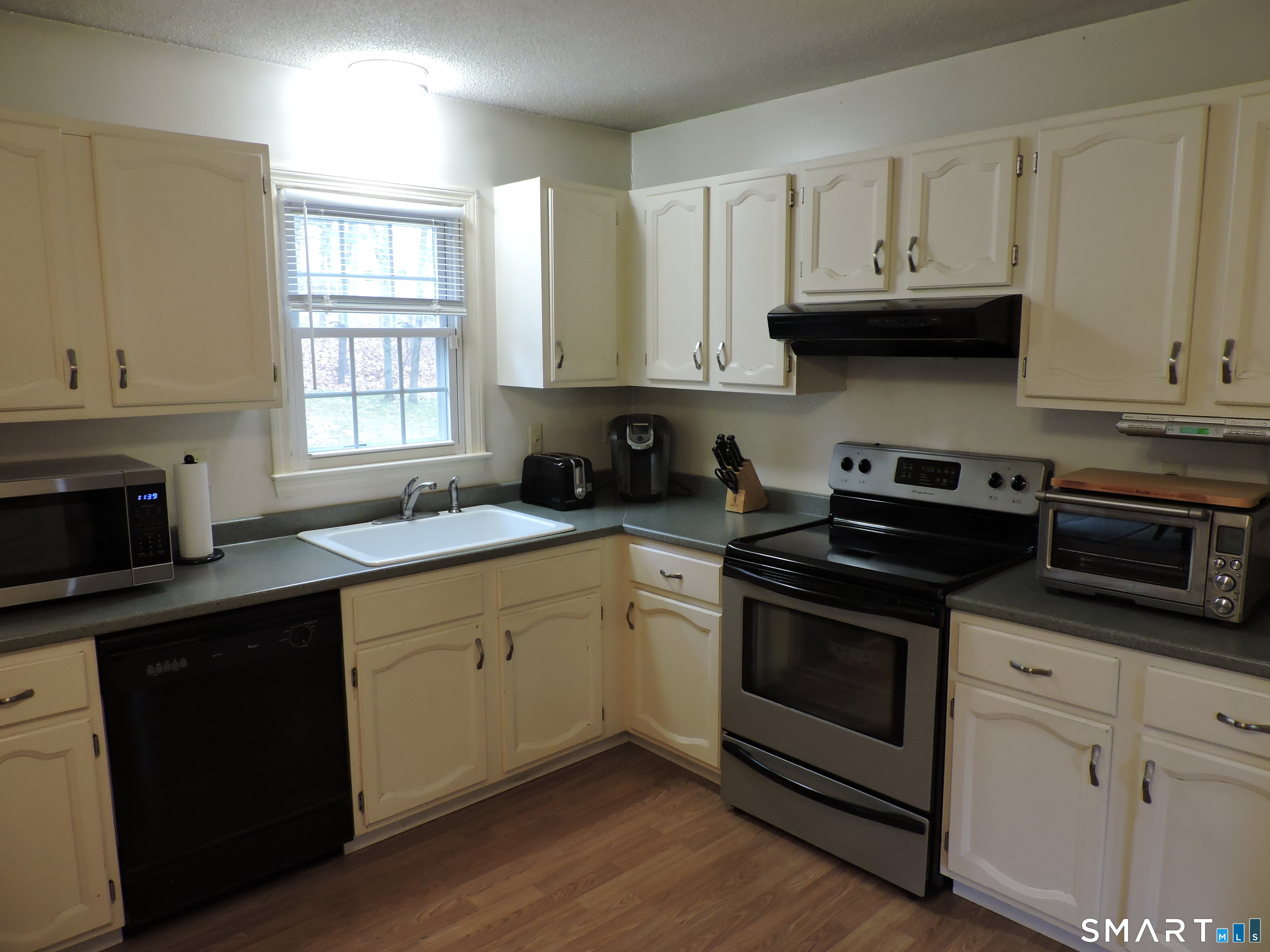 814 Graham Road South Windsor, CT 06074 - Photo 10 of 23 a kitchen with stainless steel appliances granite countertop a sink dishwasher a stove and a microwave oven with cabinets