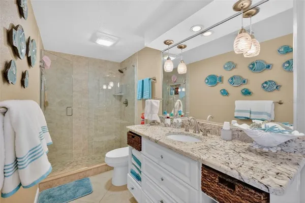 a bathroom with a double vanity sink mirror and toilet