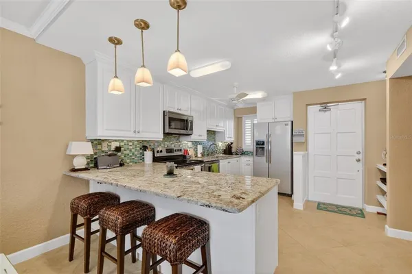 a view of a dining room with furniture a chandelier and wooden floor