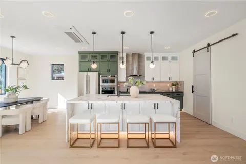 a large kitchen with a table and chairs