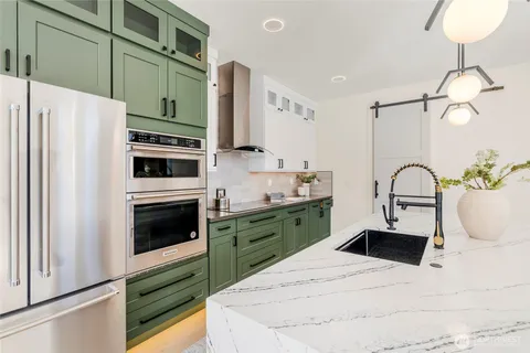 a kitchen with granite countertop a white stove top oven and cabinets