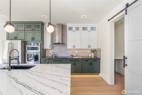 a kitchen with a sink cabinets and appliances