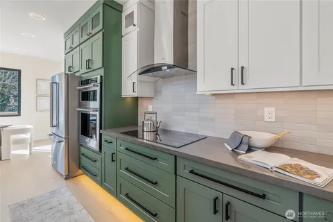 a kitchen with stainless steel appliances a sink and cabinets