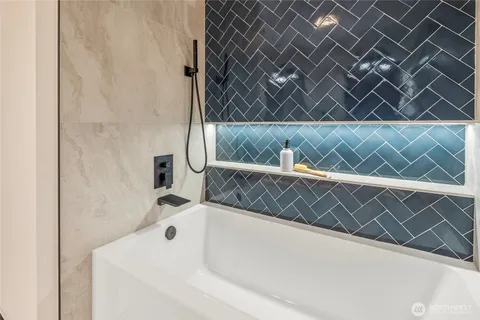 a bathroom with double vanity sinks and a mirror
