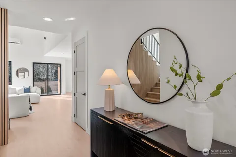 a living room with furniture and a mirror