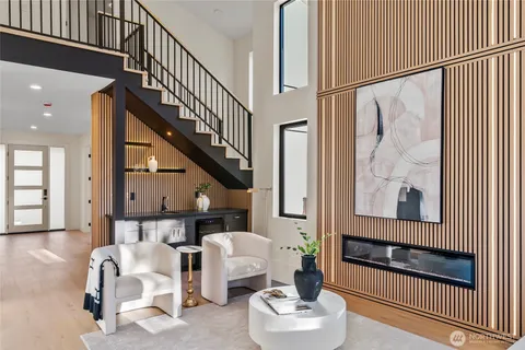 a living room with furniture and a painting on the wall