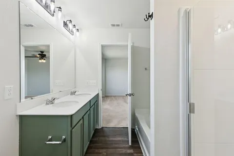 a bathroom with a double vanity sink and a mirror