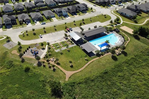 an aerial view of a residential houses with outdoor space