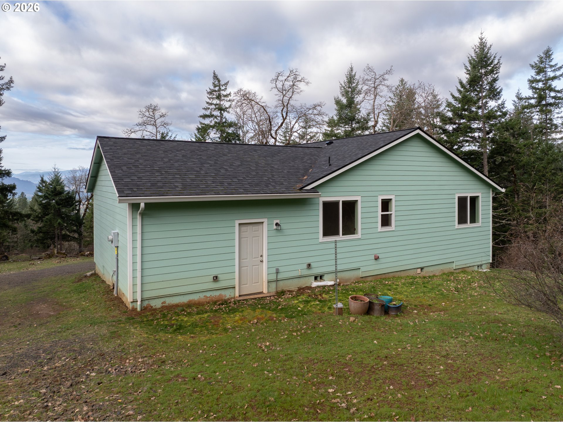 244 Lyons Road White Salmon, WA 98672 - Photo 19 of 22 a view of a house with a yard and garage