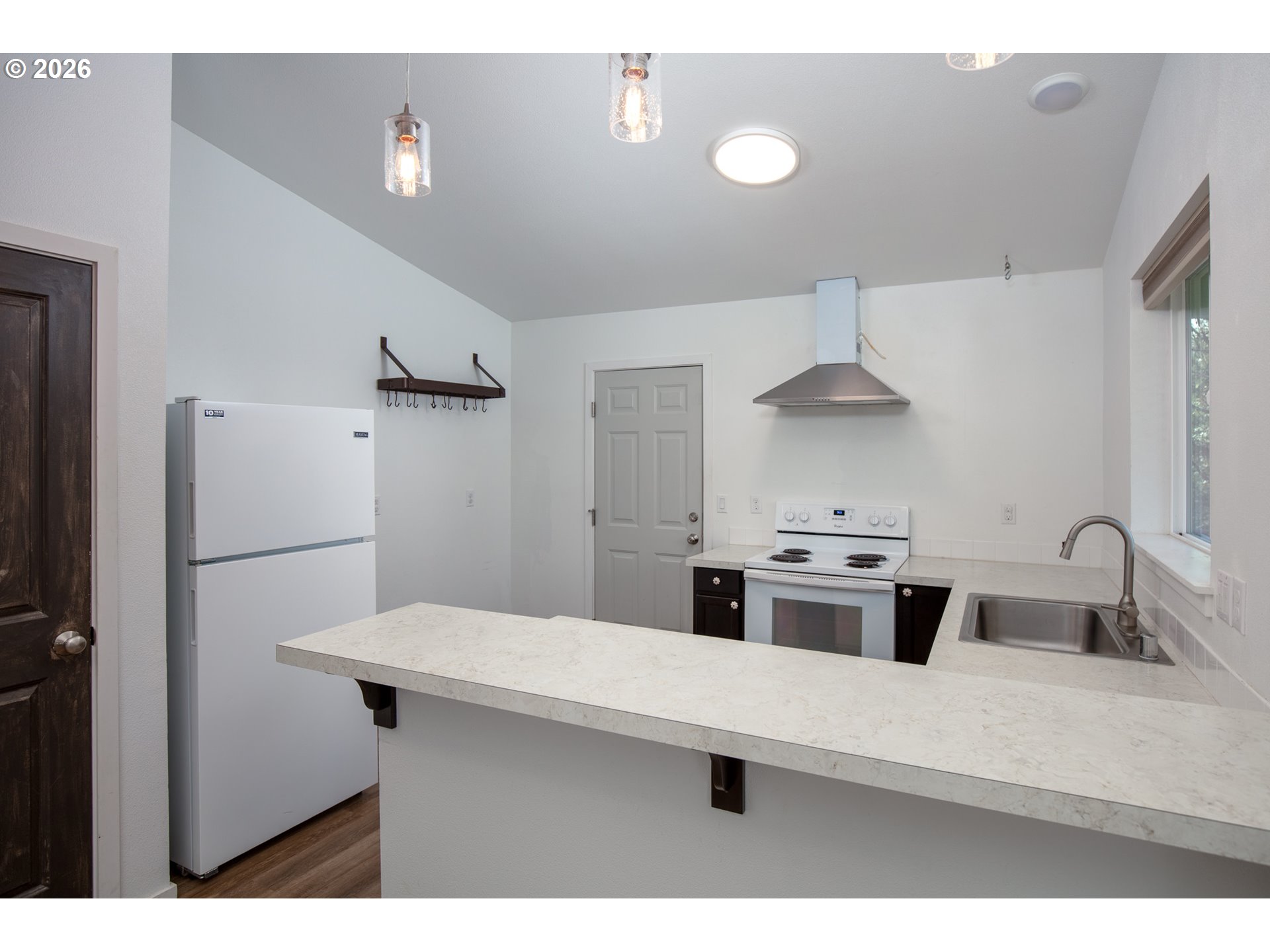 244 Lyons Road White Salmon, WA 98672 - Photo 7 of 22 a kitchen with stainless steel appliances a sink and a refrigerator