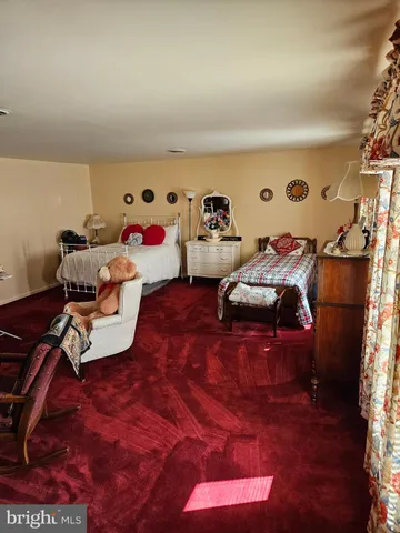 a bedroom with furniture and a flat screen tv