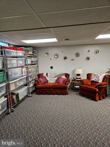 a room with lots of furniture and a book shelf
