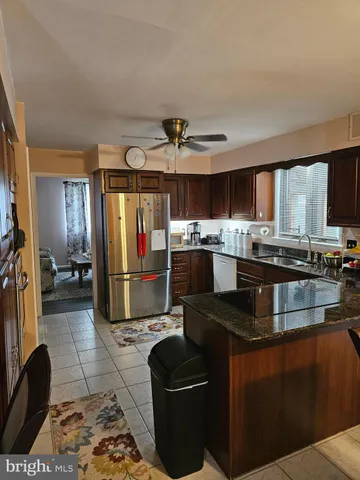 a kitchen with stainless steel appliances granite countertop a stove top oven a sink and a granite counter tops