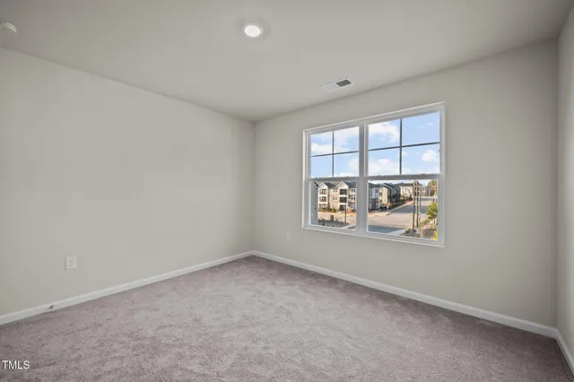 a view of staircase with wooden floor and white walls