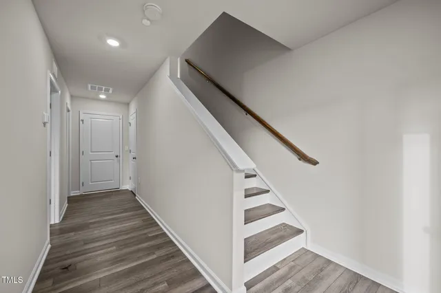 a bathroom with a granite countertop sink toilet a mirror and shower