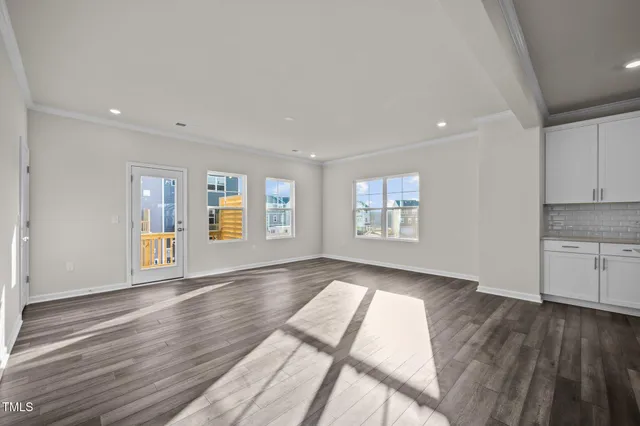 a view of kitchen and hall with wooden floor