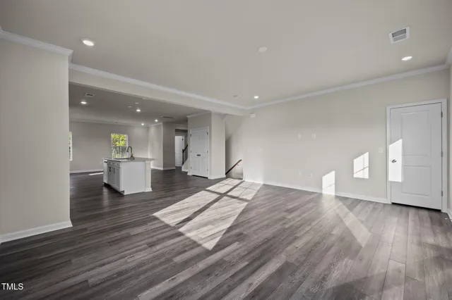 a large kitchen with stainless steel appliances lots of counter space and wooden floor