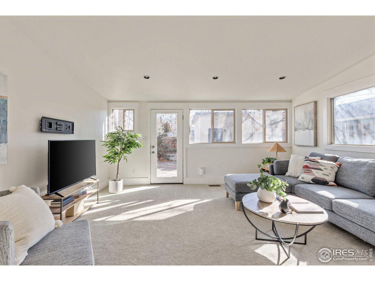 4464 Raleigh Street Denver, CO 80212 - Photo 15 of 39 a living room with furniture a flat screen tv and a large window