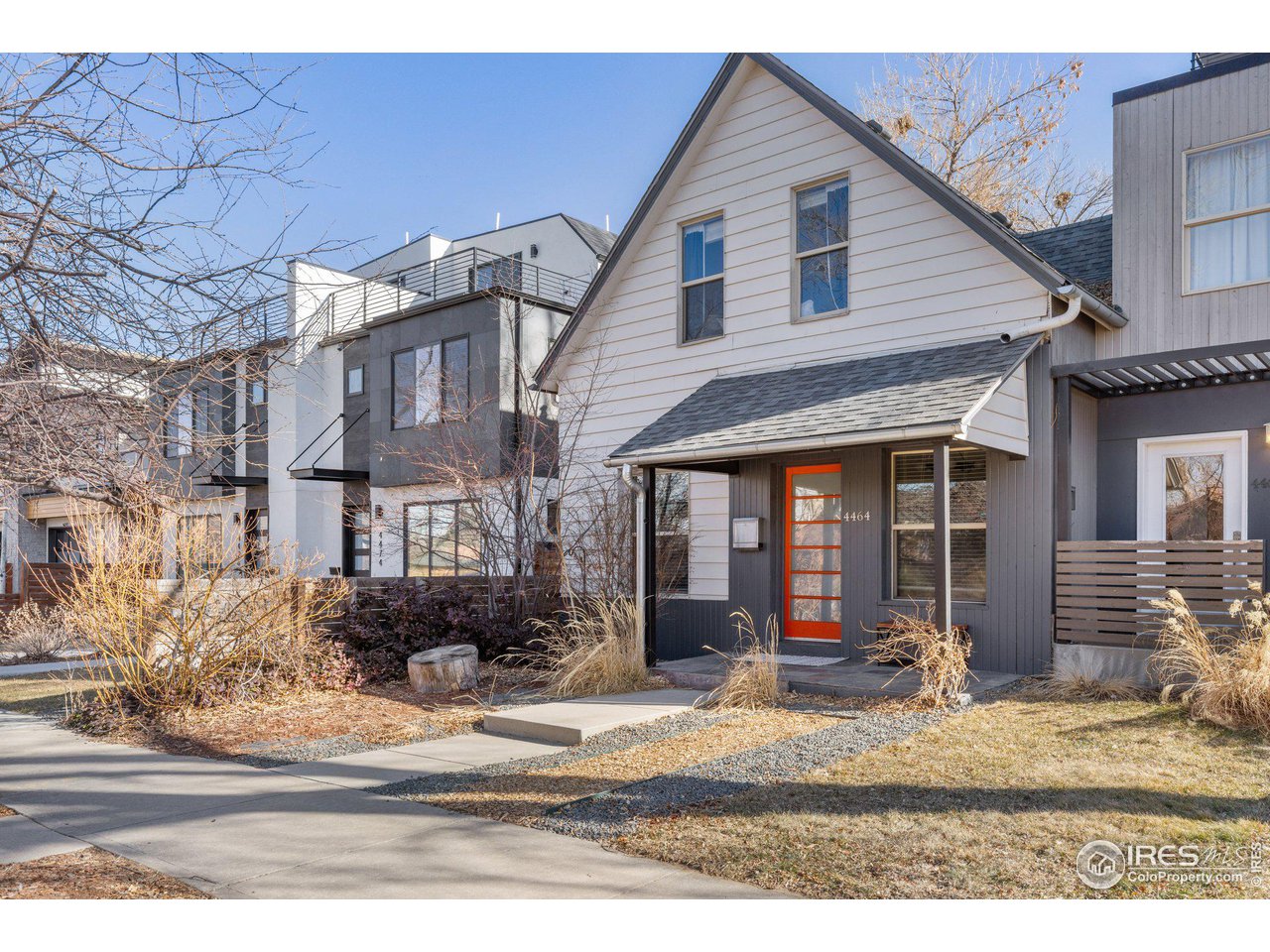 4464 Raleigh Street Denver, CO 80212 - Photo 2 of 39 a view of a white house with large windows and plants