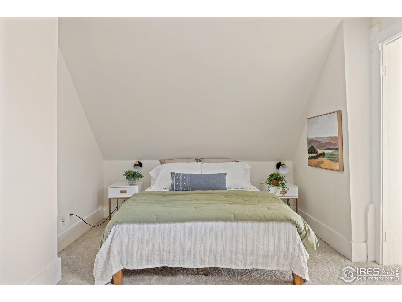 4464 Raleigh Street Denver, CO 80212 - Photo 22 of 39 a bedroom with a bed and painting on the wall