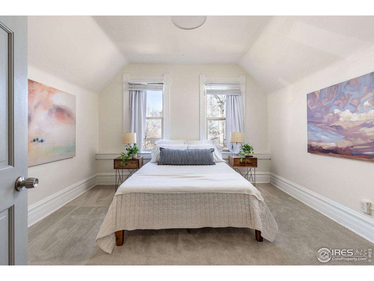 4464 Raleigh Street Denver, CO 80212 - Photo 30 of 39 a bedroom with a bed a couch and windows